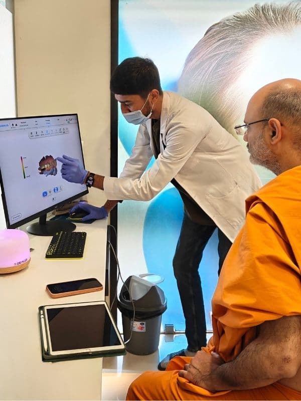 Dr. Pratik Pipalia consulting with a patient at his Rajkot dental clinic