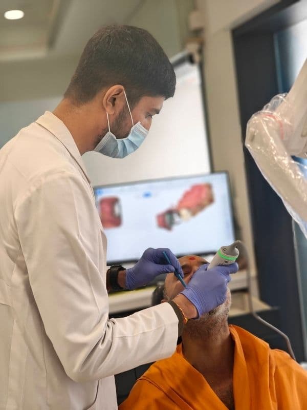 Dr. Pratik Pipalia taking a digital intraoral scan for dental implants in Rajkot